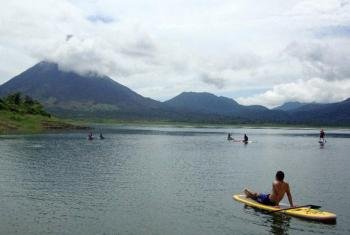 Stand up paddle boarding in Arenal Lake, Costa Rica photo